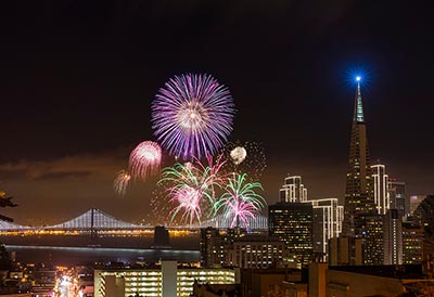 Fireworks at San Francisco downtown New Year. Bay bridge and downtown on the background.