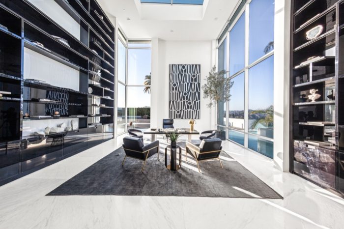 Black and white meeting room with floor to vaulted ceiling plate glass windows