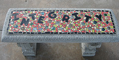 Stone bench with the word "integrity" embedded into a mosaic