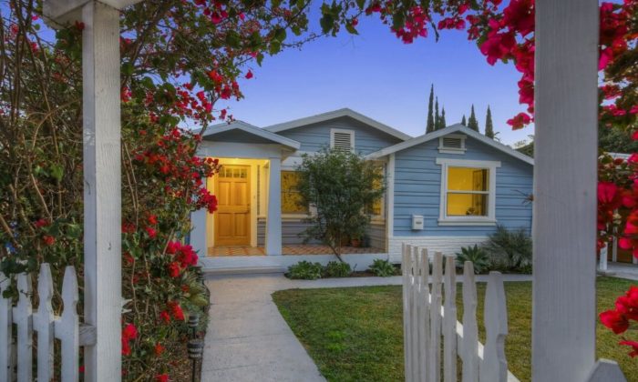 California bungalow house at dusk with rose trellis in foreground