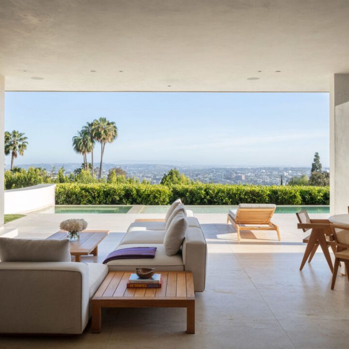Outdoor living area with view of city and palm trees