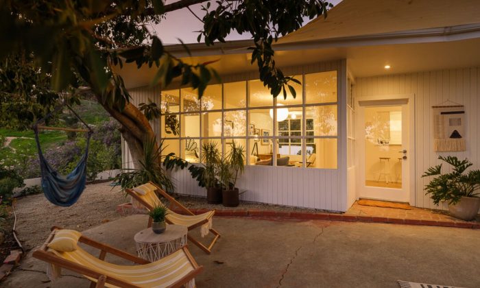 Mid centur modern house with closed in porch lights on