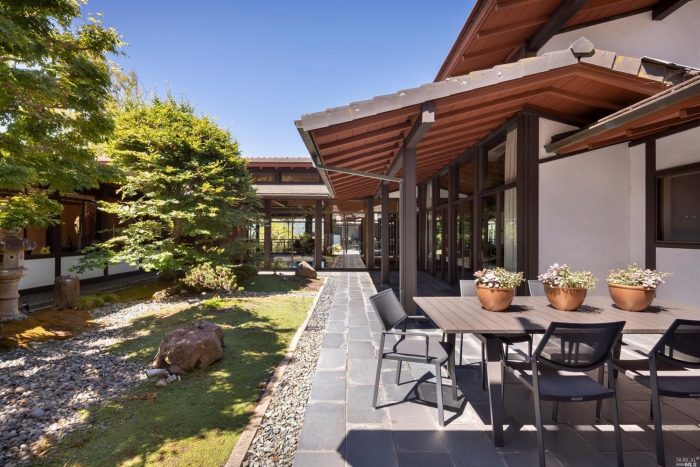 Patio with outdoor table and chairs landscaping, designed by Nagao Sakuri