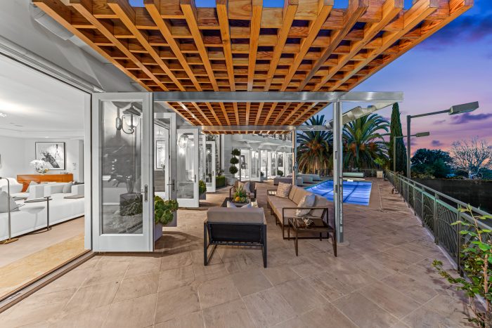 Tiled outdoor patio, with wood beams. 