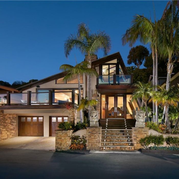 Beach front estate with palm trees after dusk