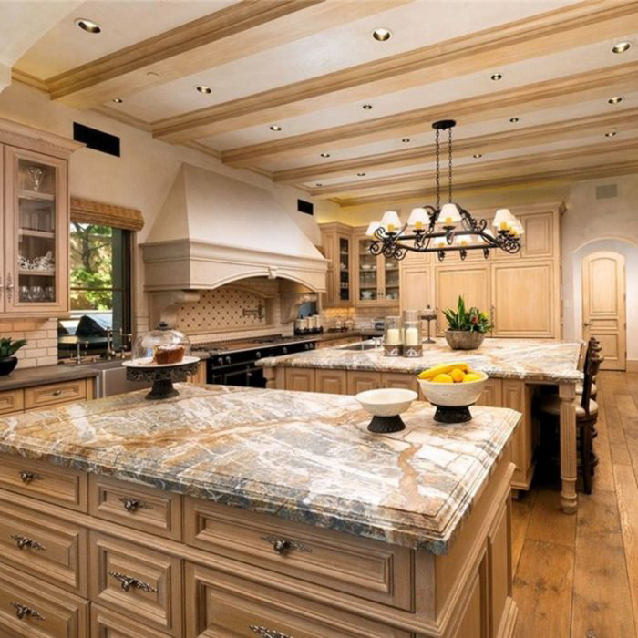 Lightwood kitchen with white grey beige marble counter top and black wrought iron chandelier 