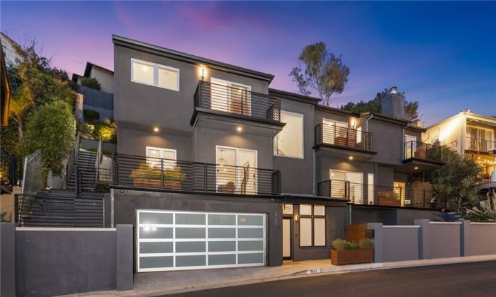 condo with lights on interior at sunset