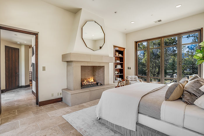 Primary bedroom suite with fireplace in Central Portola estate