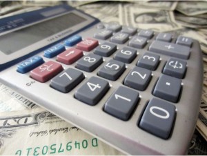 Image of a calculator on a pile of money