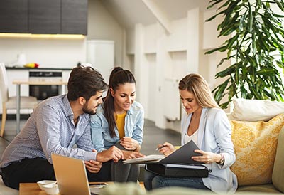 Young couple talking with a real estate professional