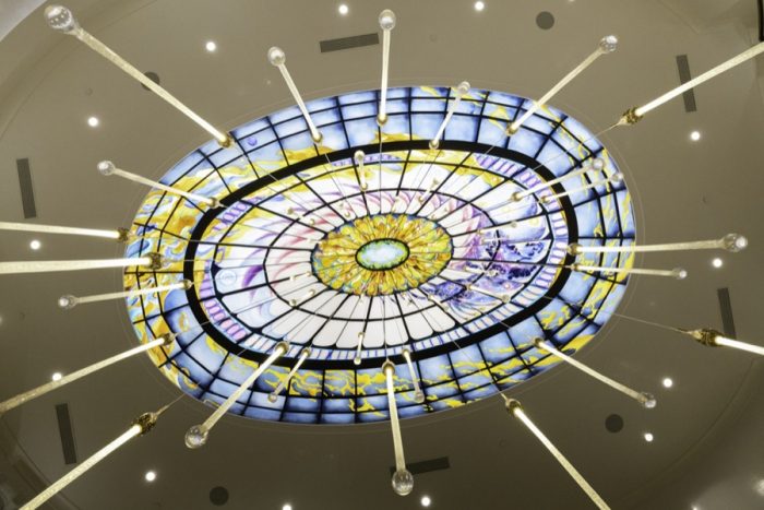 Glass dome, purple and yellow with light features. 