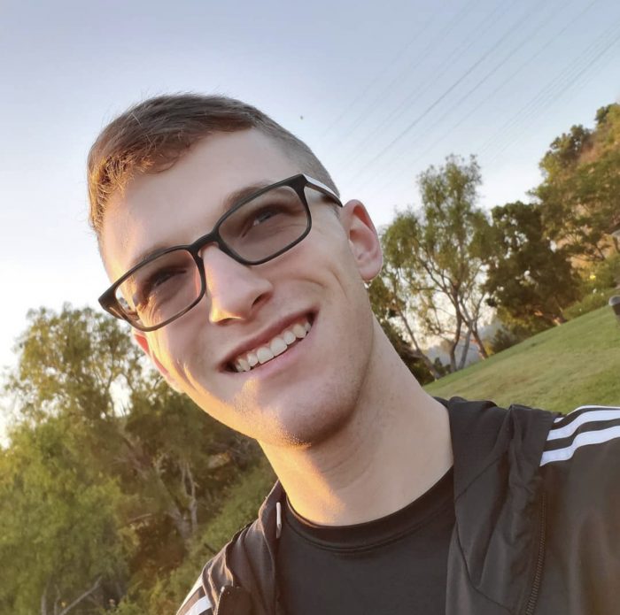 Kyle Carter, Office Administrator = Man with glasses at the park.