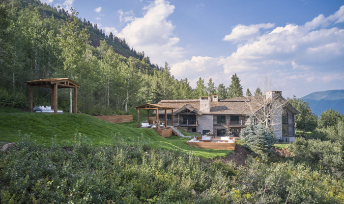 Mountain home on a green hillside.