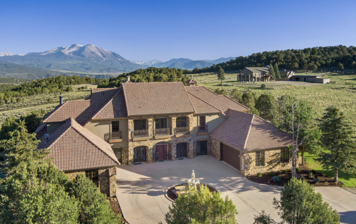 County road property with mountains in the background. 