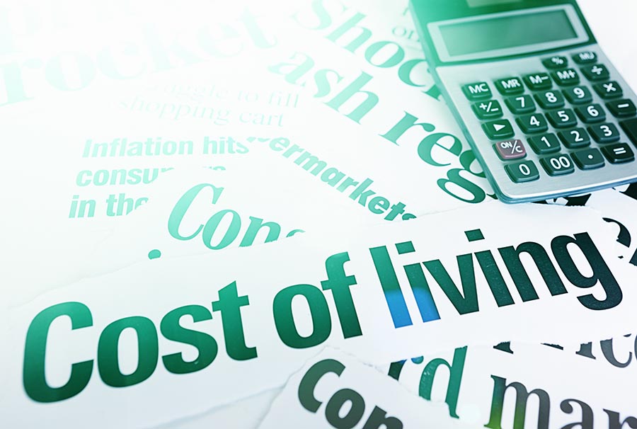 Stack of headlines on Cost of Living plus calculator