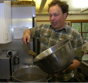 John Heylin scoops crickets into a pot of water.