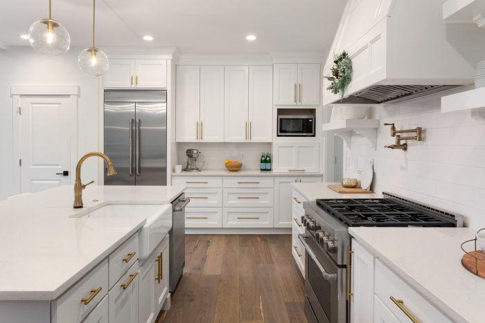 A clutter-free kitchen with plenty of cabinets and a walk-in pantr