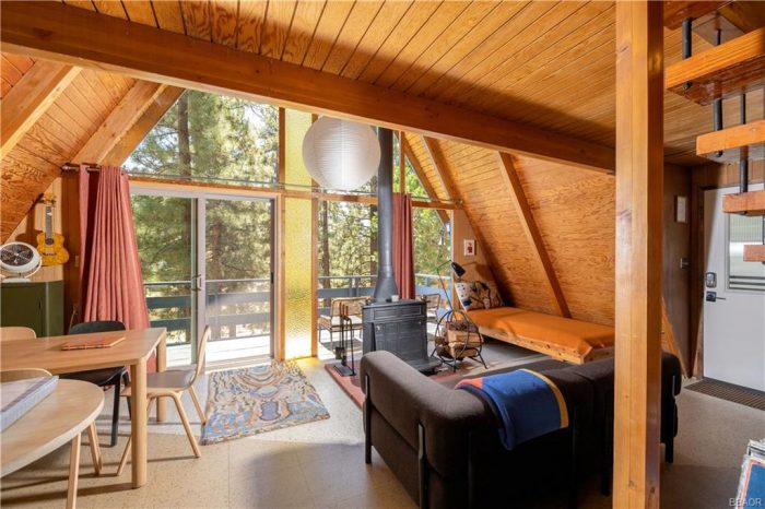 Interior of A frame with wooded beams and woodstove.