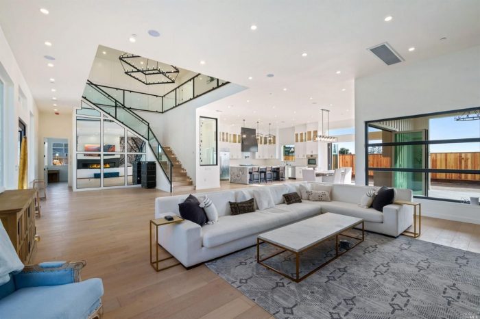 Modern open living space with 12 foot ceilings and furnishings