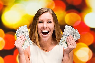 Smiling woman holding cash