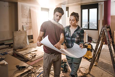 Young couple studying remodeling plans